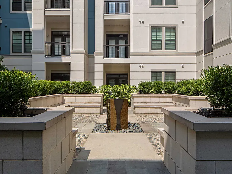 Decorative fountain with stone bench seating around