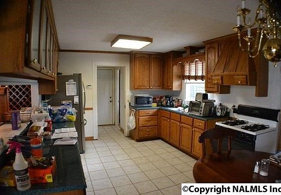 Ceramic tile flooring, double doors to back patio, lots of cabinets