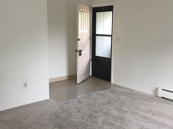 View from the inside of the apartment towards entry door. Screened storm door allows summer breezes in.