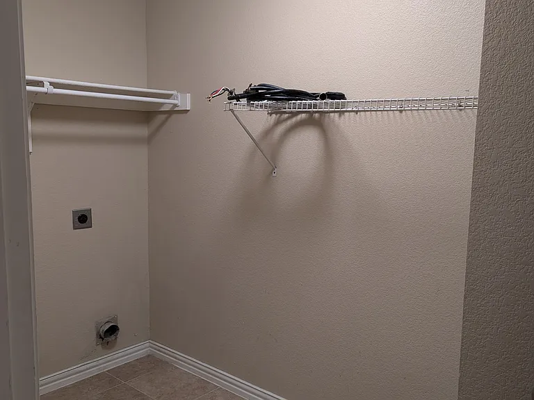 Utility washer/dryer room next to garage entry on first floor