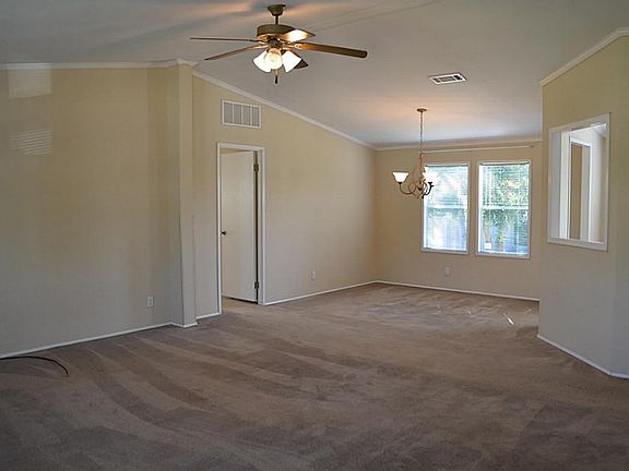 This shows the formal living room looking into the formal dining room. A large area ideal for entert
