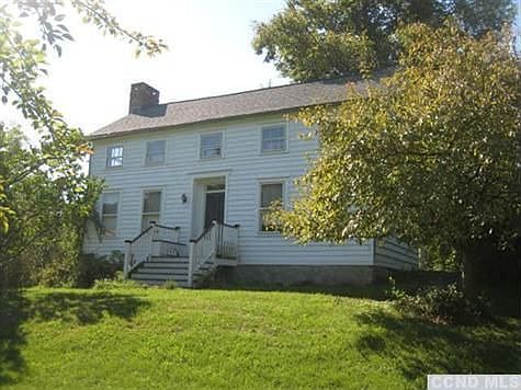 Three bedroom Farmhouse nicely sited on a slight rise set back from road on over 3 acres of land.