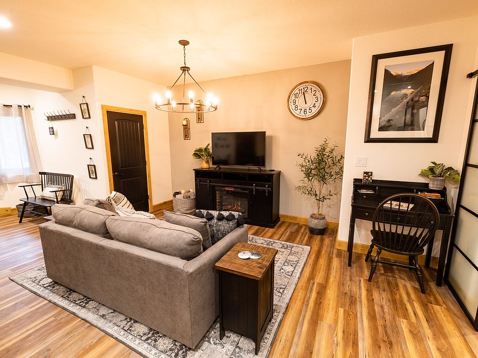 Living area with workspace and electric fireplace