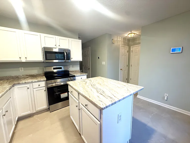 Brand new granite counter tops and flooring finish off this beautiful kitchen.