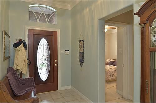   The inviting entry is tiled, which flows into much of the rest of the home.