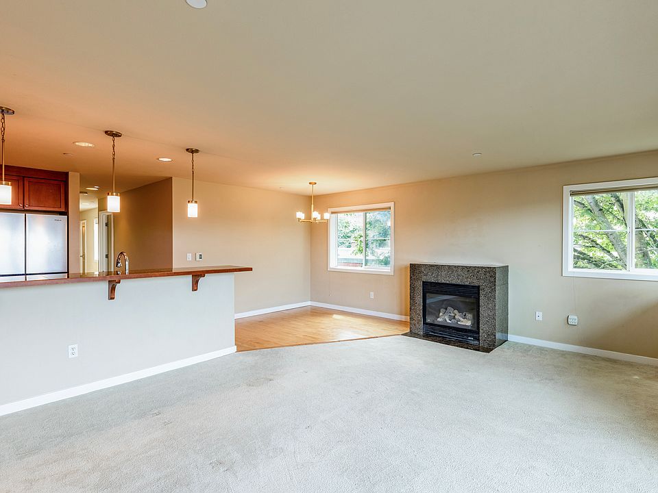 The large living room and open kitchen provide lots of space for cooking, dining, and relaxing.