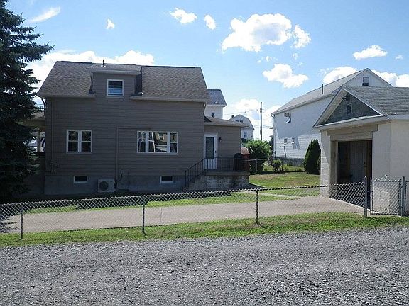 Side view w/ drive & garage