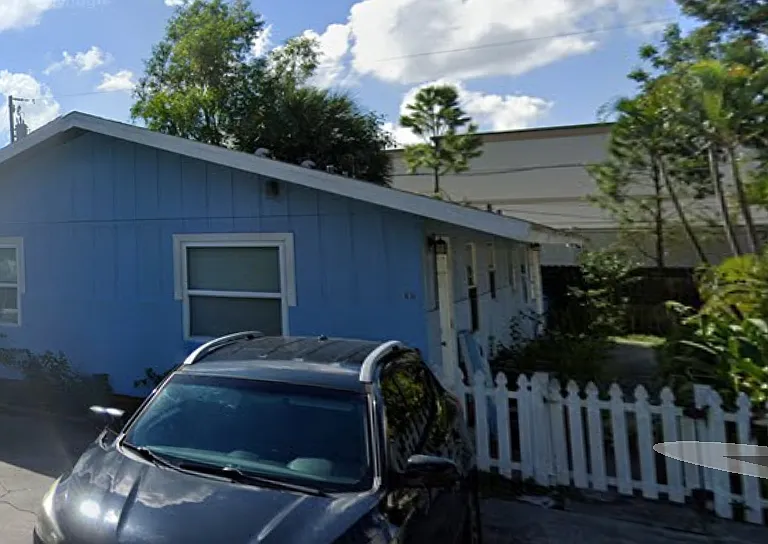 It is the front unit of the blue duplex. There is a small fenced in yard shared with the other tenant. Off street parking.