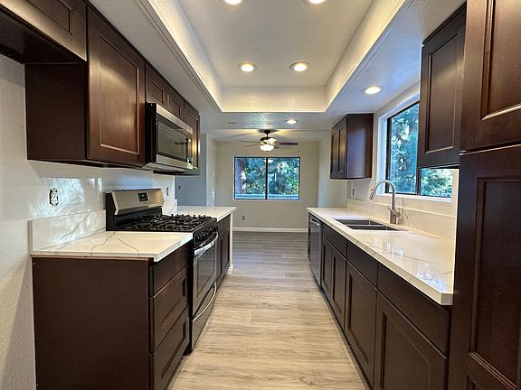 New kitchen viewed from entry hall. Kitchen has 8 ceiling lights.