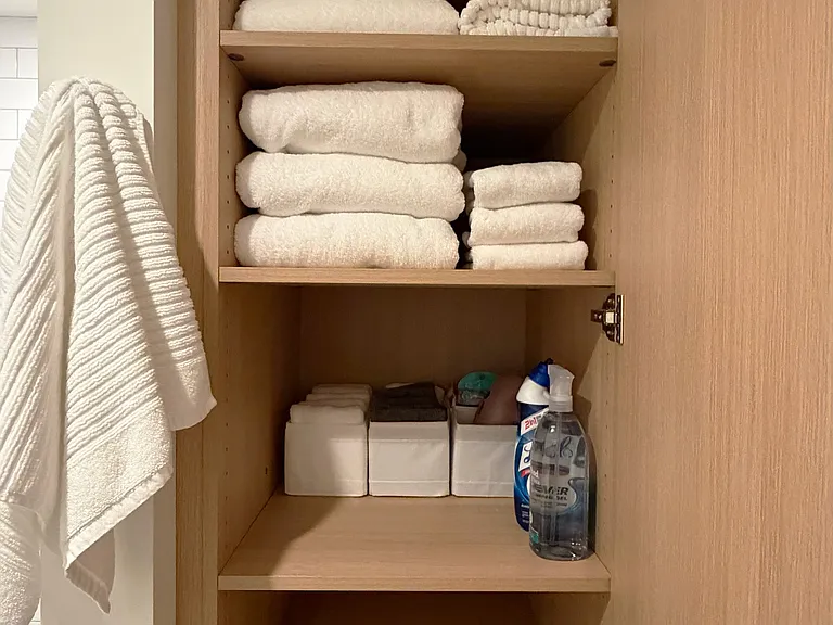 Bathroom Cabinetry with Plenty of Fluffy New Towels, New Hair Dryer and Starter Amenities