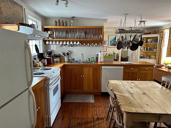 View of the main part of the kitchen from the Back Bedroom. The kitchen floor is original.