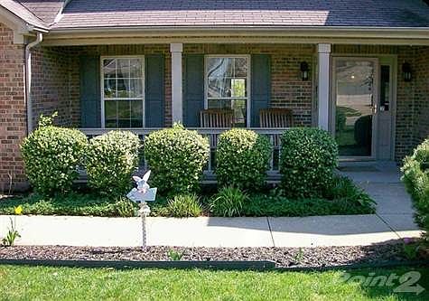 Traditional covered front porch / plenty of room for rocking chairs and friends / brick front / beautifully landscaped.