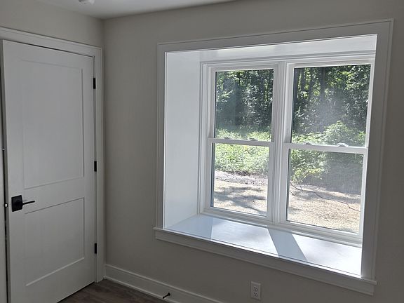 Bedroom box window overlooking back wooded yard