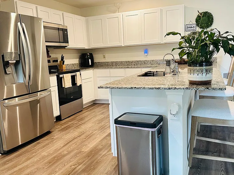 Kitchen with stainless steel appliances and farm sink.