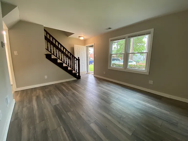 Living room view to front window and stairs
Agreeable gray throughout with gloss white trim