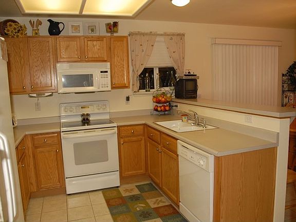 Warm and Inviting Kitchen and Dining Area Replete with Ceramic Tile