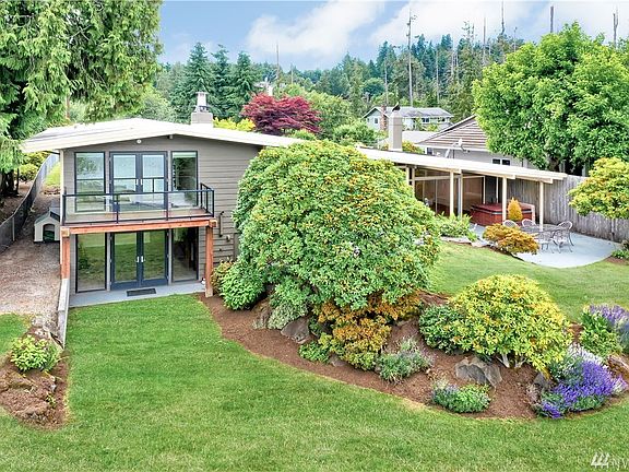 Lake Stevens views from most rooms in this unusually wide, 3,100sf tri-level home with entertainment-sized backyard that slopes 