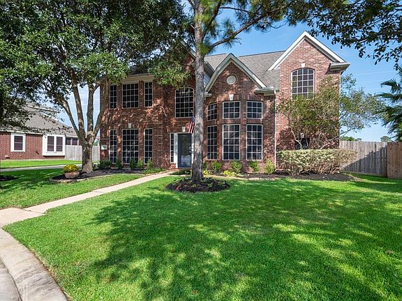 The curb appeal is enhanced by mature trees and a lush lawn. The inside is a showstopper. Let's take a look.