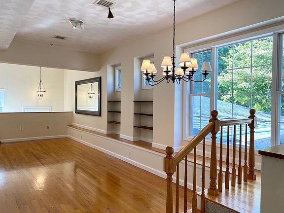 Living/dining area looking from kitchen .Large picture window overlooking private, fenced in rear yard for the exclusive use of this condo.