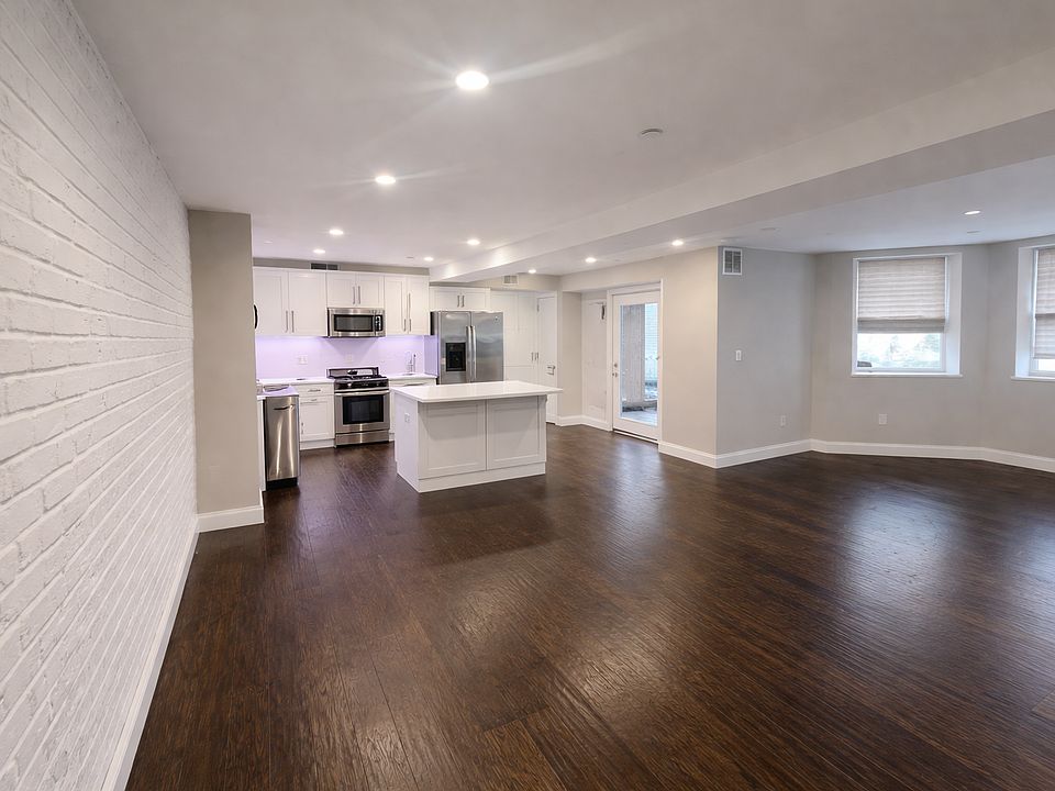 View of the living room, dining room and kitchen from the main building entrance.