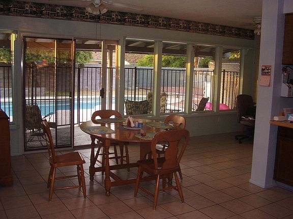 Kitchen, dining room and breakfast nook overlook pool & patio