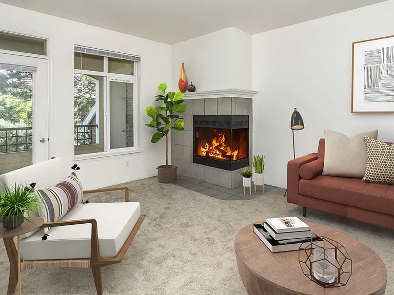Carpeted Living Room with Fireplace and Balcony