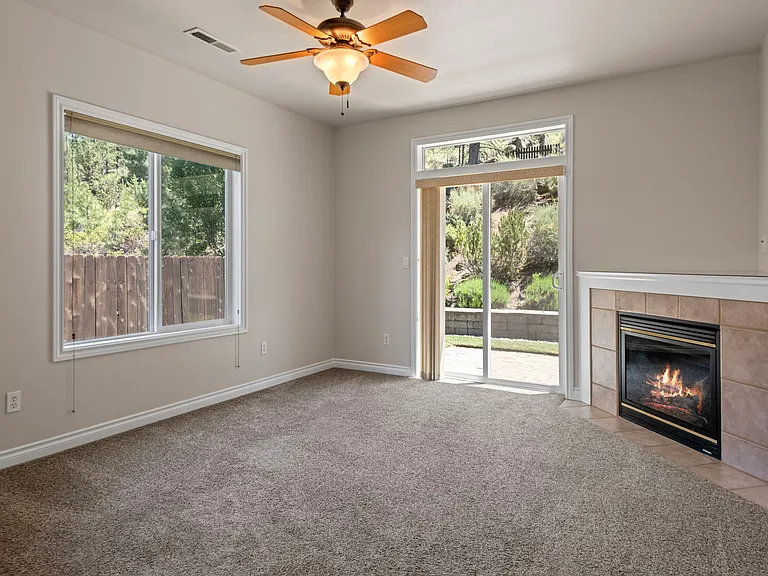 Living room with sliding glass doors leading out to the paver patio.