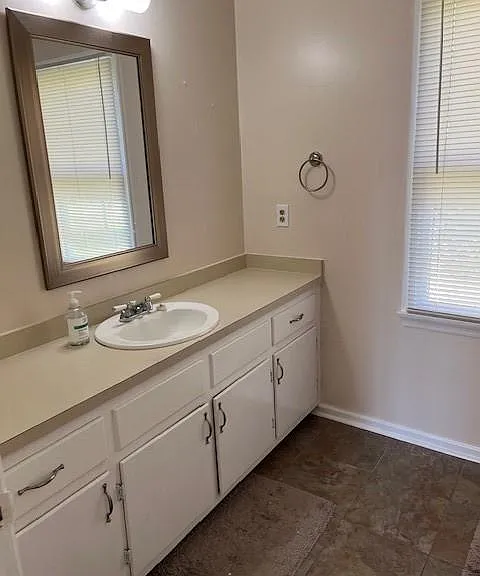 Sink view inside the door area-this large bathroom has ceramic tile