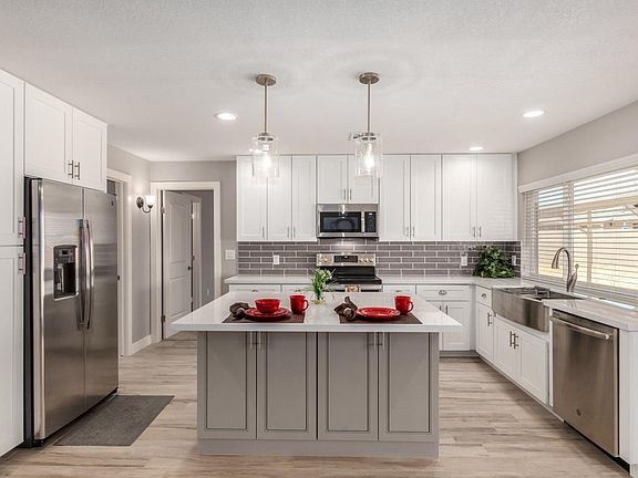 Stainless steel appliances with white shaker cabinets. Plenty of storage for all your kitchen items!