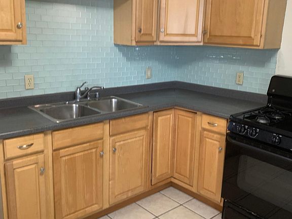 Large, eat-in kitchen with lovely tile backsplash.