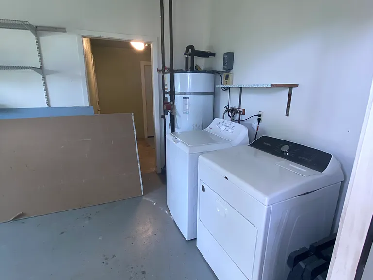 Laundry room with washer, dryer and large solar heated hot water tank