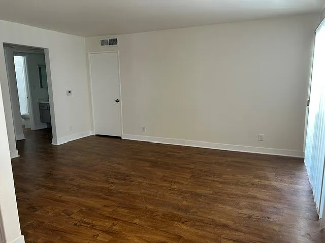 Living room with fire place, coat closet, and walk out balcony