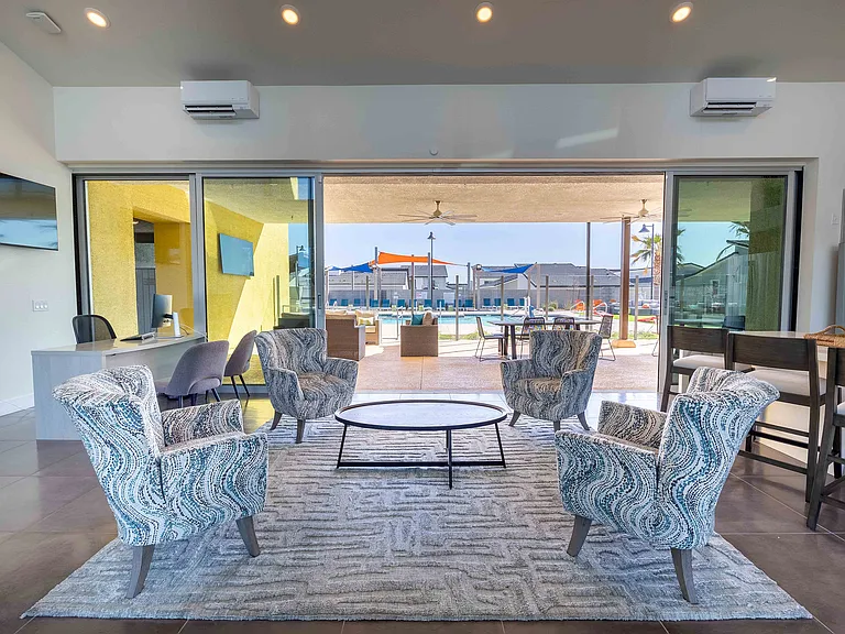 Experience elegance and comfort in this inviting lounge that opens up to a vibrant pool area.