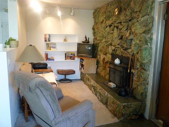 Cozy little sitting room area with big rock fireplace-sit up close and take a nap on a rainy afterno