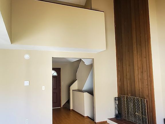 Very tall ceilings make the living room feel spacious while the wood detail keeps it warm