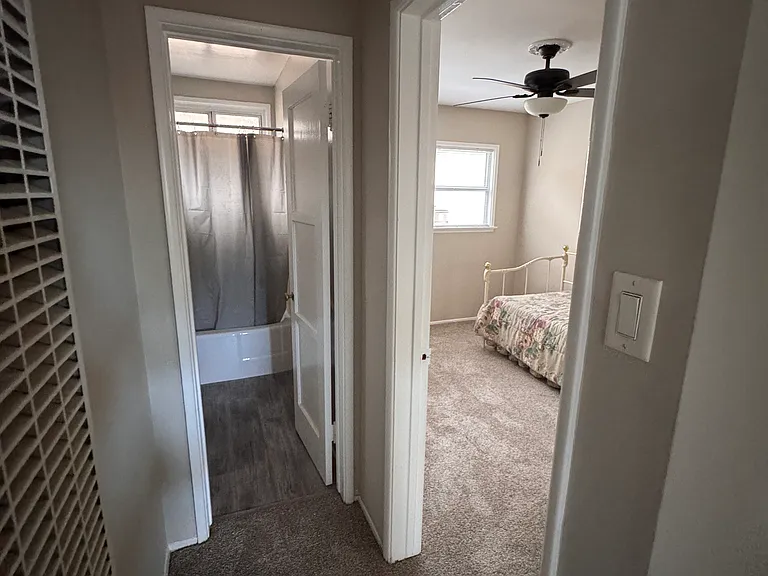 Hallway with the split view of the second bedroom and bathroom