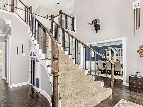 The Entry is STUNNING with a grand Staircase elegantly splitting at the top into two landings to access both sides of the home and Gameroom. Wrought Iron spindles have been added and the wood has been stained a darker color to match the recent wood f