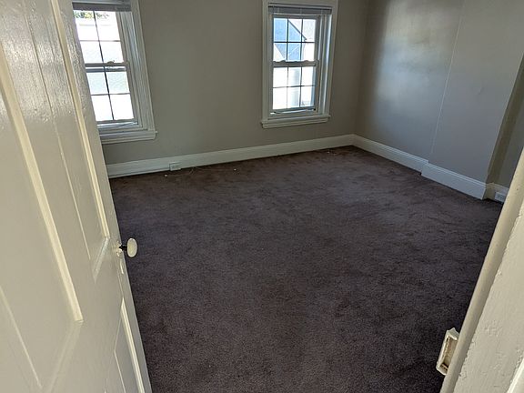 3rd floor master bedroom, view from door of street-facing windows.