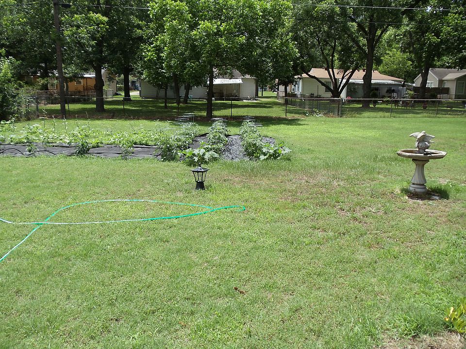 Large fenced backyard with l
