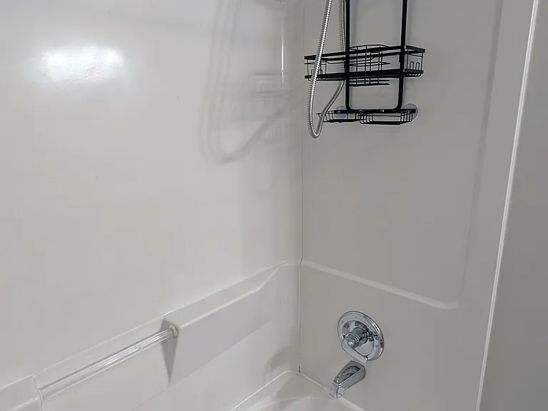 Tub and shower with hand-held shower head.