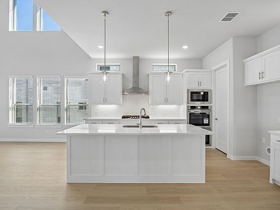 Kitchen in the Monet II home plan by Trophy Signature Homes - REPRESENTATIVE PHOTO
