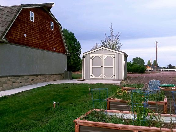 Multiple raised garden beds, private yet unfenced and welcoming yard, plus a perfect size storage shed. A beautiful country feel.