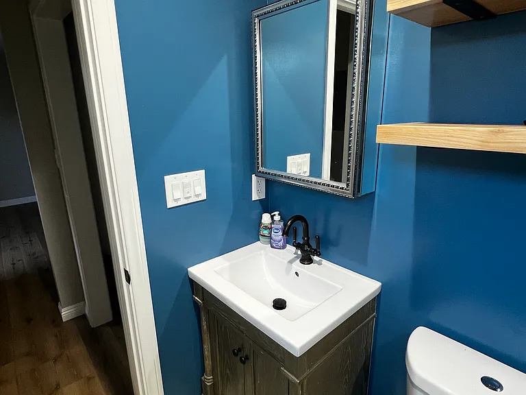 Newly installed shelves above toilet