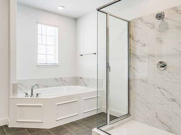 Primary bedroom has separate tub and shower