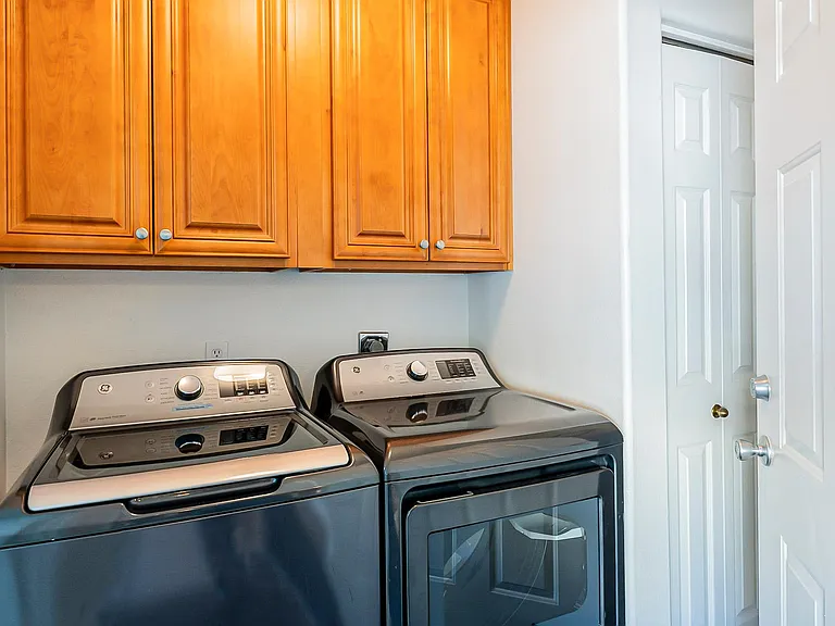 Enclosed Laundry Room has Newer Full Size Washer and Dryer