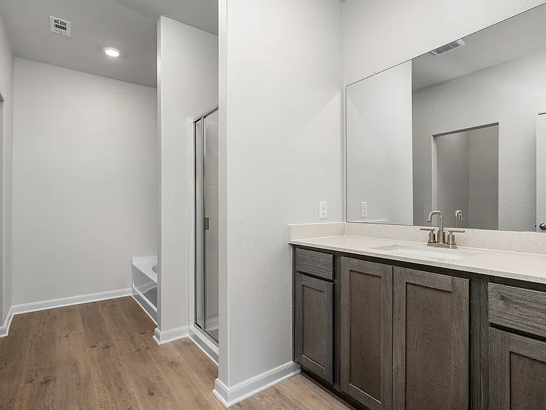 The master bathroom has a sprawling dual-sink vanity.