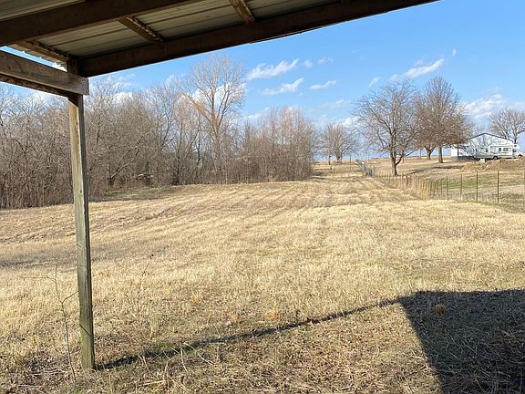 Under loafing shed facing north side of property.