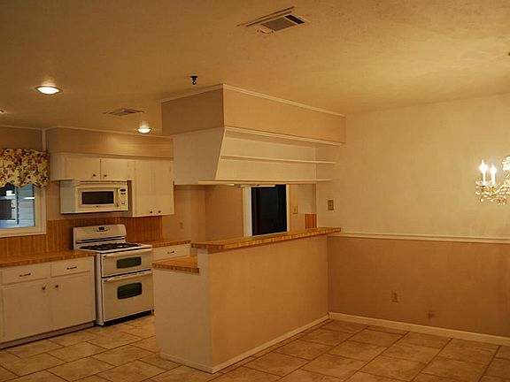 Kitchen in open to the Dining Room with a Breakfast Bar in between. An adorable built in shelf above is the perfect place to display china or keep your favorite cookbooks!