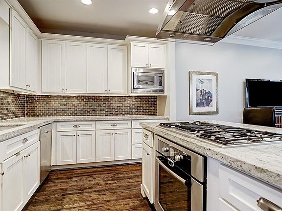 This amazing kitchen - open to the living/dining areas - features stainless steel Bosch appliances, granite counters, tons of cabinet space and a breakfast bar.