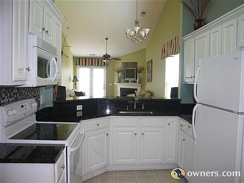 Kitchen with granite countertops and bar